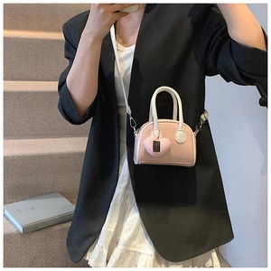 Pink mini shell handbag for girls with plush heart charm and detachable shoulder strap