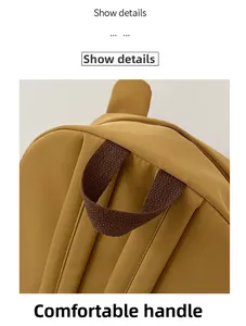 Détail de la poignée tressée marron renforcée et des coutures du sac à dos jaune
