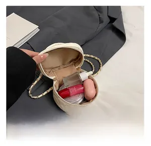 Internal view of cream quilted mini chain bag showing storage capacity for cosmetics