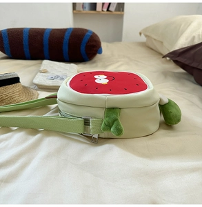 Detail of anthropomorphic watermelon crossbody bag with cute face and plush feet