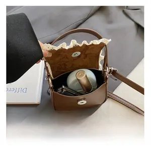 Détail de l'intérieur du mini sac en cuir PU marron avec fermoir aimanté et dentelle