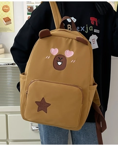 Détail d'un sac à dos mignon ours brun avec oreilles et broderies fines