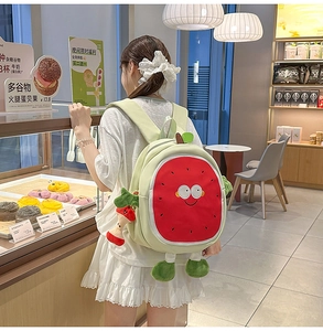 Cute cartoon watermelon backpack with embroidered face detail and soft plush charm