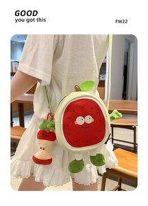 Detail of plush watermelon crossbody bag with a cute apple charm and smiling face