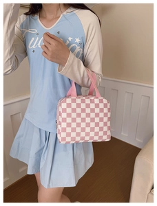 Close-up of pink and white checkered lunch bag with zipper and pink webbing handle