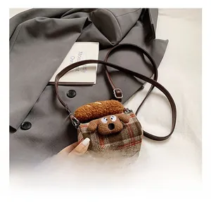 Detail of red-brown checkered cylinder bag with cute 3D dog and bread ornaments