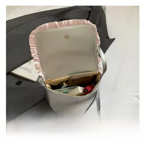 Interior view of silver crossbody bag showing capacity for phone and lipstick