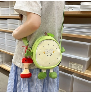Cartoon fruit guava crossbody bag with apple pendant worn by a model in casual setting