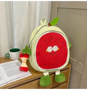 Detail of cute watermelon backpack with cartoon face and plush apple core keychain