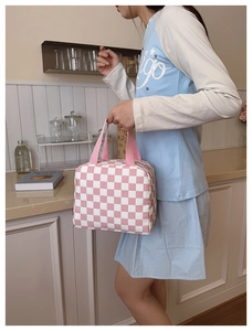Detail of pink and white checkered lunch bag with sturdy fabric handles for daily use