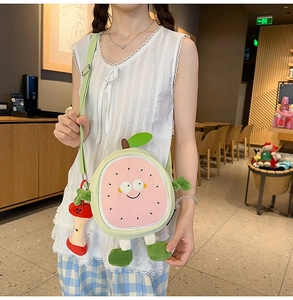 Close-up of cute cartoon fruit guava crossbody bag with apple pendant accessory