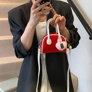 Mini red shell handbag for girls with white handles and pink heart plush charm