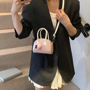 Mini shell-shaped pink and white handbag for girls featuring a sweet heart pendant
