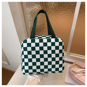 Close-up of a green checkered lunch bag showing durable fabric and reinforced handles