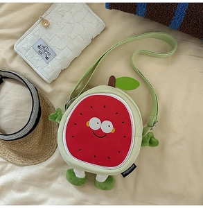 Detailed view of plush watermelon crossbody bag with cute face and soft green limbs