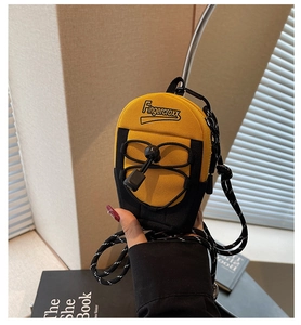 Detailed close-up of a mini yellow and black crossbody bag with Fingercroxx embroidery