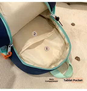 Internal view of navy canvas backpack showing main pocket and tablet compartment