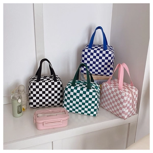 Detail view of four checkered canvas lunch bags with zipper closure and lunch box set