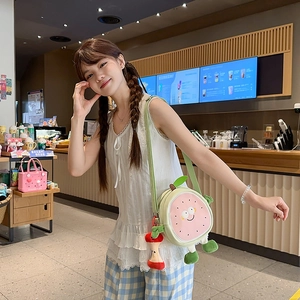 Cute fruit-shaped crossbody bag with a smiling guava design and green shoulder strap