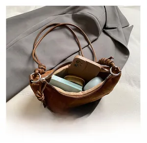 Interior view of brown suede croissant bag showing storage capacity for daily essentials
