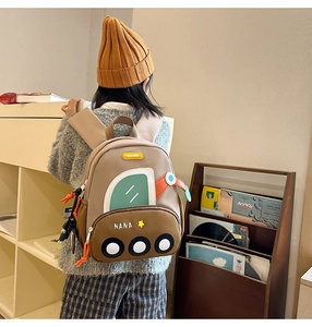 Detailed view of lightweight kids bus-shaped backpack with comfortable padded shoulder straps
