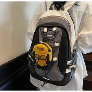 Detail of grey color-block backpack with yellow pouch and adjustable drawstrings