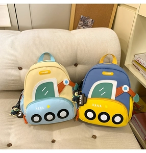 Detail view of colorful excavator-shaped backpacks with cute zipper doll pendants