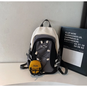 Detail view of mini crossbody bag with functional drawstring and yellow round pouch