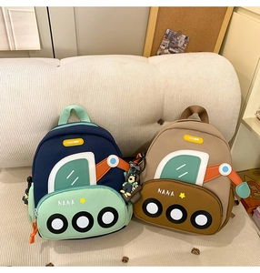 Close-up of cute cartoon car-shaped backpacks with NANA embroidery and dog charms
