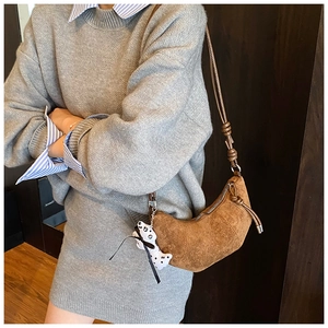 Kid's brown suede crescent bag with knot detail and polka dot animal pendant