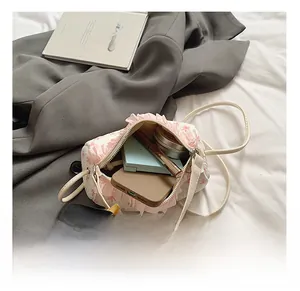 Internal view of a small cylinder bag showing capacity for lipstick and phone