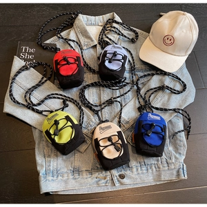 Mini crossbody bags for girls in five vibrant colors displayed on a denim jacket