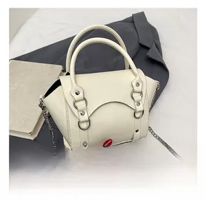 Detail of off-white patent leather winged handbag with silver chain strap and metal ring