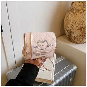 Detail of pink quilted crossbody bag with cat embroidery and leather strap for girls