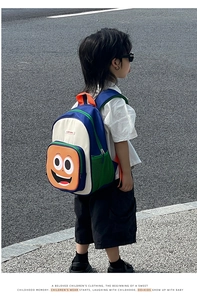 Detail of color-block kids backpack with cute smiling face and mesh water bottle pocket