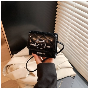 Detail of a mini quilted black cat bag with cute embroidery and a slim shoulder strap