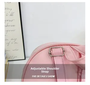 Close-up of the adjustable shoulder strap and silver buckle on the pink children's backpack