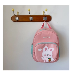 Pink canvas children's backpack with cute white rabbit print and side mesh bottle pocket