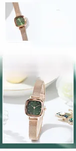 Detailed macro view of GEDI emerald green square watch face with rose gold mesh strap