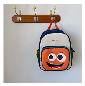 Detail of colorful children backpack with cartoon face and side mesh pocket
