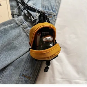 Mini yellow canvas crossbody bag for kids with metal zipper and adjustable strap