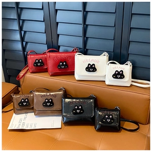 Detail of cute cat crossbody bags for kids in four colors with embossed letters