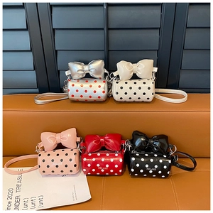 Polka dot mini cylinder shoulder bags with large bow handles in five vibrant colors