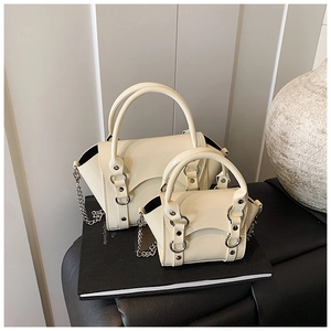 Detail of cream white leather mini chain bags with silver metal rings and studs