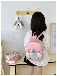 Detailed back view of a pink PU unicorn backpack with rainbow sequins on a child model