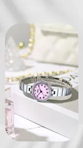 Gros plan d'une montre à quartz argentée avec cadran rose sur décor élégant
