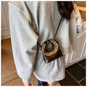 Detail of kids brown mini crossbody bag with yellow checkered ruffle on grey sweater