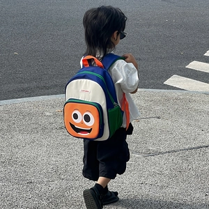 Cute cartoon children backpack with smiley face and colorful contrasting panels