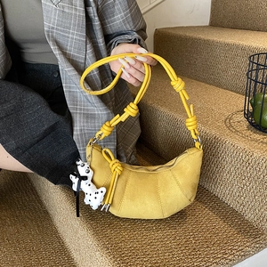 Minimalist yellow suede crescent bag for kids with unique knotted strap and dalmatian charm