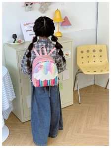 Close-up of pink toddler backpack featuring sequin rainbow and cloud applique details